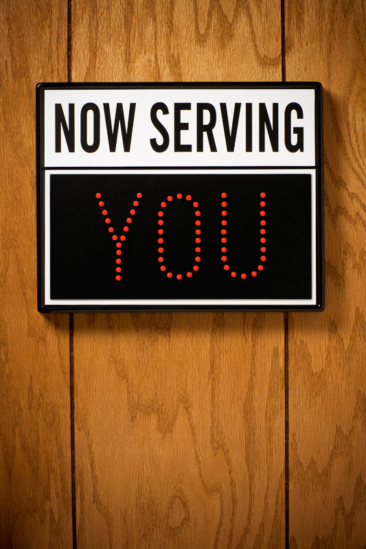 Photograph of "Now Serving" sign indicating "You" © Dana Hursey Photography